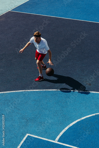 high angle view of young sportsman playing basketball on court © LIGHTFIELD STUDIOS