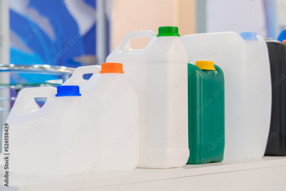 Row of empty plastic jerrycans at factory, exhibition - close up. Manufacturing, recycling, industry, technology equipment concept Row of empty plastic jerrycans at factory, exhibition - close up. Manufacturing, recycling, industry, technology equipment concept