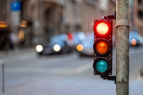 traffic light on the street junction with beautiful bokeh, city with cars in the background
