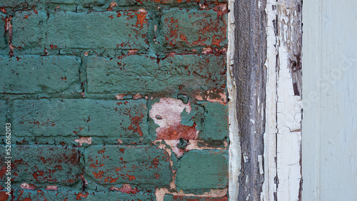 Old vintage red brick and peeled paint wall masonry exterior.