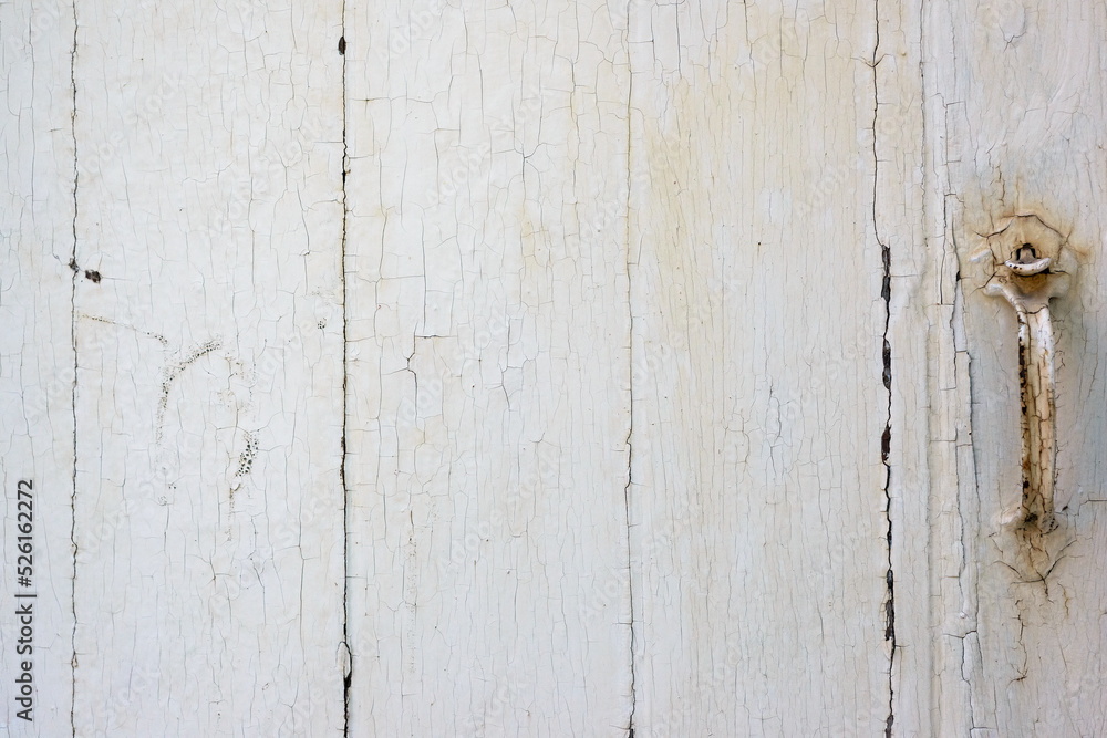 Painted old wood background - A white wood wall with cracks and lines breaking up the peeling tan paint. Painted old wood background - A white wood wall with cracks and lines breaking up the peeling tan paint.