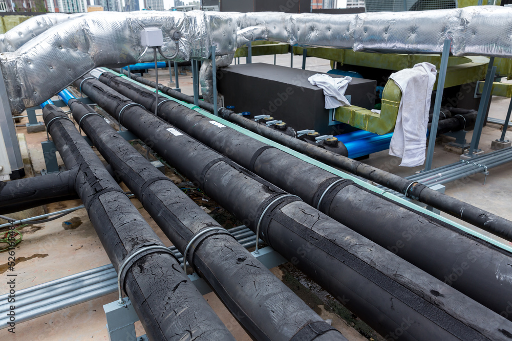Pipe of air conditioner system on roof. a lot of pipe for air conditioner system. Industrial air conditioning tubes. Ventilation system and pipe systems installed on industrial building. Pipe of air conditioner system on roof. a lot of pipe for air conditioner system. Industrial air conditioning tubes. Ventilation system and pipe systems installed on industrial building.