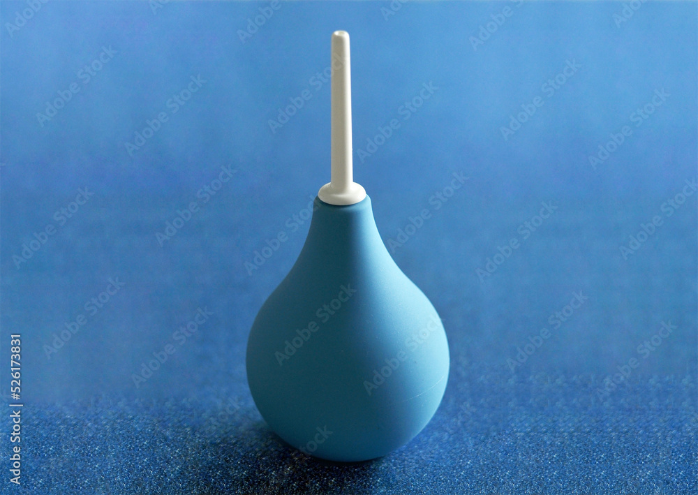 blue hand cleansing enema on beautiful background blue hand cleansing enema on beautiful background