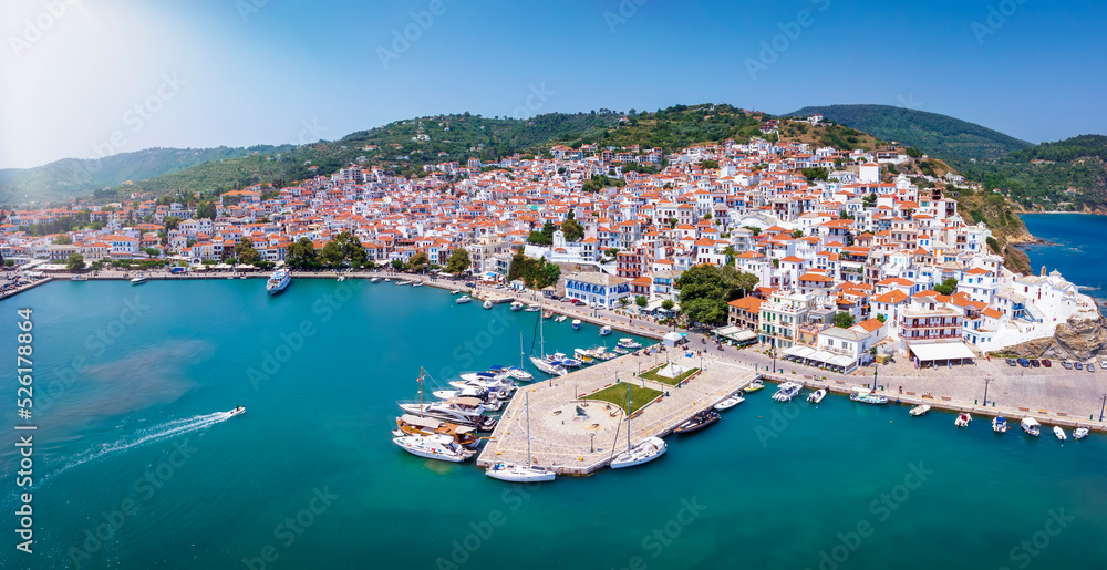 Panoramic aerial view of the beautiful town and harbour of Skopelos island with the traditiona, red roofed white houses, Sporades, Greece