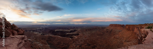 Scenic Panoramic View of American Landscape and Red Rock Mountains in Desert Canyon. Cloudy Sunrise Sky. Canyonlands National Park. Utah  United States. Nature Background Panorama