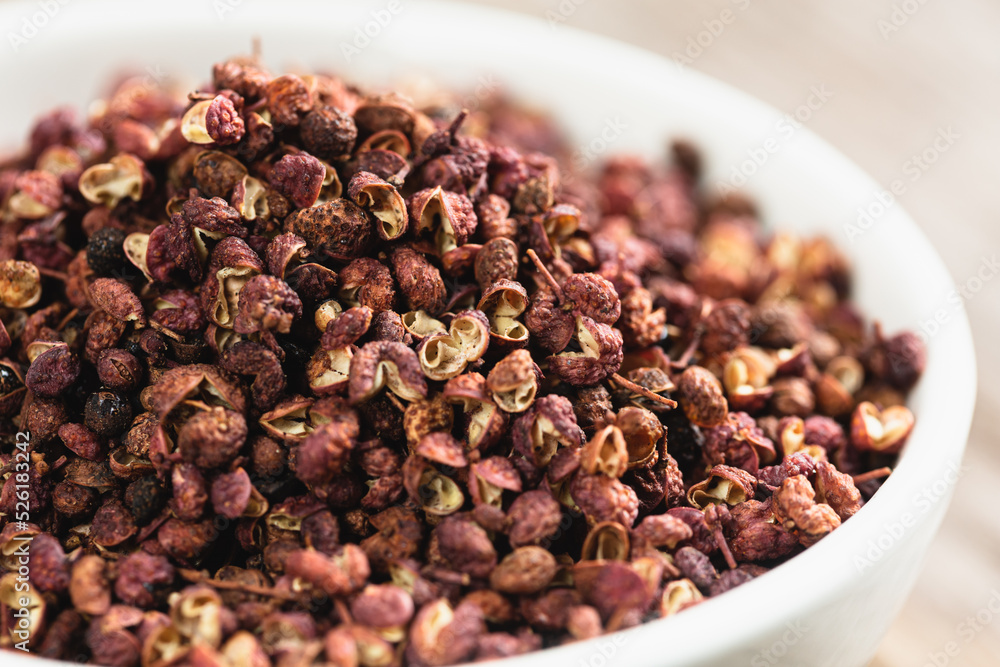 white bowl full of Sichuan peppercorns white bowl full of Sichuan peppercorns