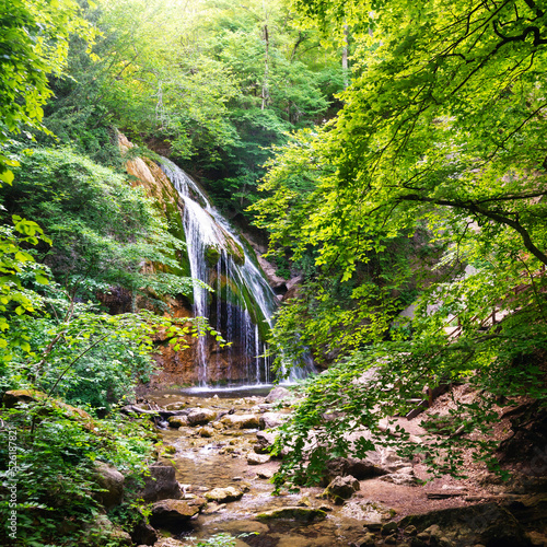 Beautiful waterfall in the summer forest