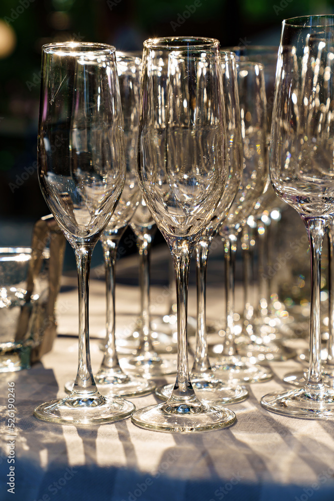 empty wine glasses on an open-air table. the sun's rays in the glass. empty wine glasses on an open-air table. the sun's rays in the glass.