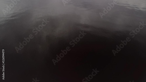 
drone flight over the river in cloudy weather