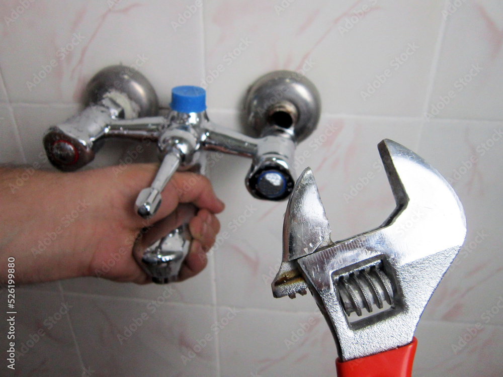 Man repair and fixing shower faucet in bathroom. Man repair and fixing shower faucet in bathroom.