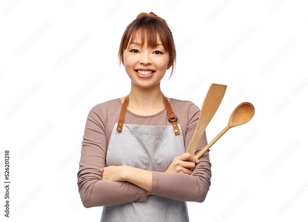 cooking, culinary and people concept - happy smiling female chef in apron  with wooden spoon over white background Stock Photo | Adobe Stock