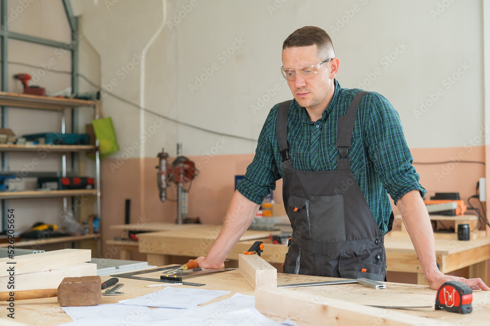 Portrait of a handsome male carpenter in the workshop. Portrait of a handsome male carpenter in the workshop.