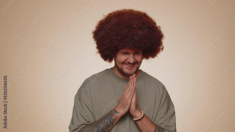 Sneaky cunning man with tricky face gesticulating and scheming evil plan, thinking over devious villain idea, cunning cheats, jokes and pranks. Young guy on beige studio wall background alone indoors Sneaky cunning man with tricky face gesticulating and scheming evil plan, thinking over devious villain idea, cunning cheats, jokes and pranks. Young guy on beige studio wall background alone indoors