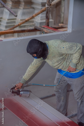 Professional painters are painting the interior of the house.