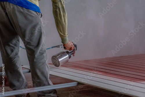 Professional painters are painting the interior of the house.