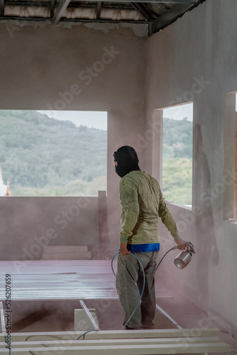 Professional painters are painting the interior of the house.