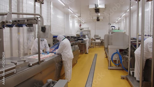Industrial production line for the production of bacon for shops. Cutting, labeling, packaging