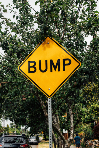 yellow "Bump" road sign
