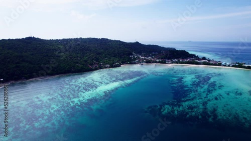 Koh phi phi island at thailand. Aerial drone view from island  coast line. sunny day resort and hotels blue wateer photo