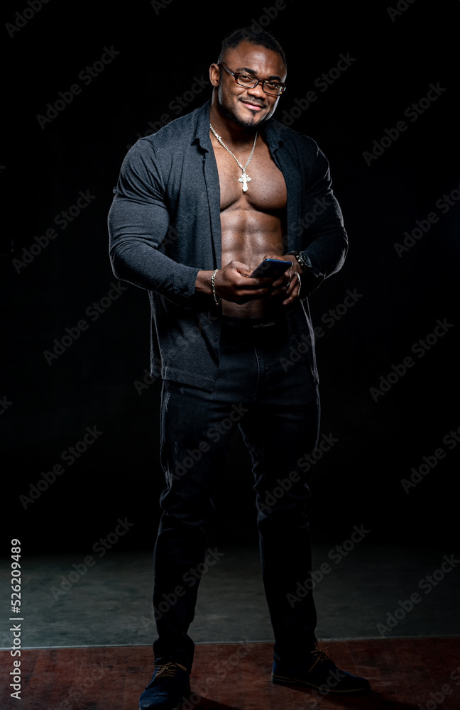 Young strong macho. Sexy shirtless muscular man on dark background.