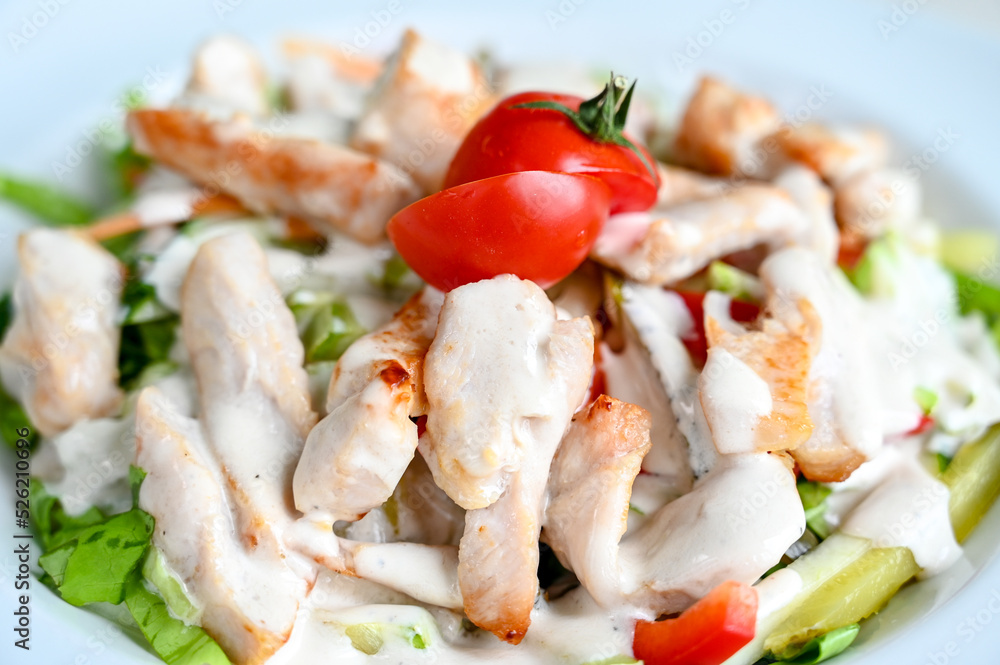 Chicken salad served on the table in restaurant. Chicken meat for lunch.