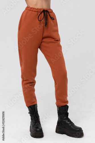 Brown jogger pants mockup. Template sports trousers front view for design. Fitness wear isolated on white