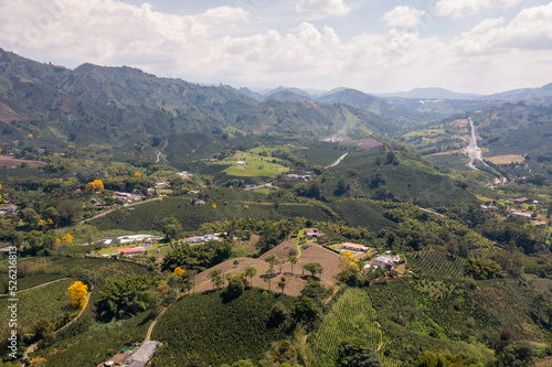 Agricultural fields between hills with dirt roads between them in a Colombian landscape