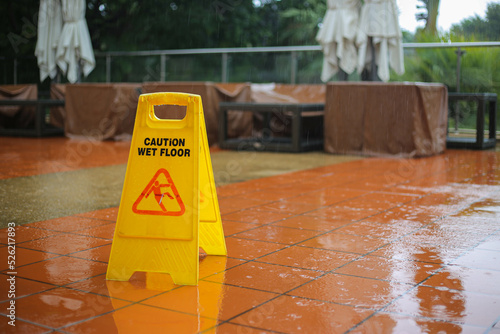 Caution wet floor yellow sign warning while it raining outside. Safety first and need to be clean. protect from injury slippery to the ground.