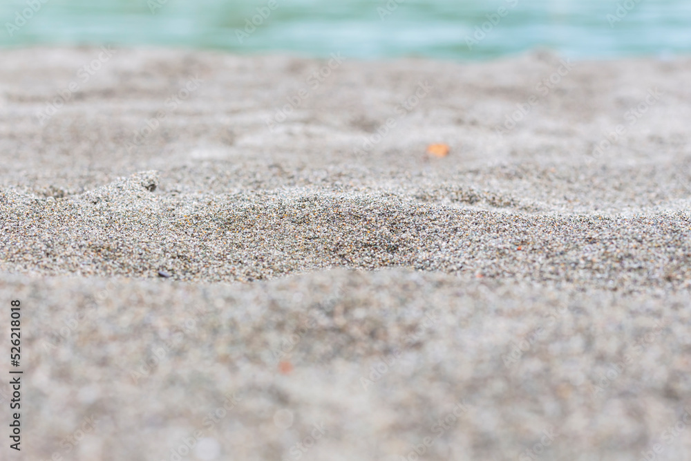 Beach sand blue sea water summer background with shallow depth of field. Beach sand blue sea water summer background with shallow depth of field.