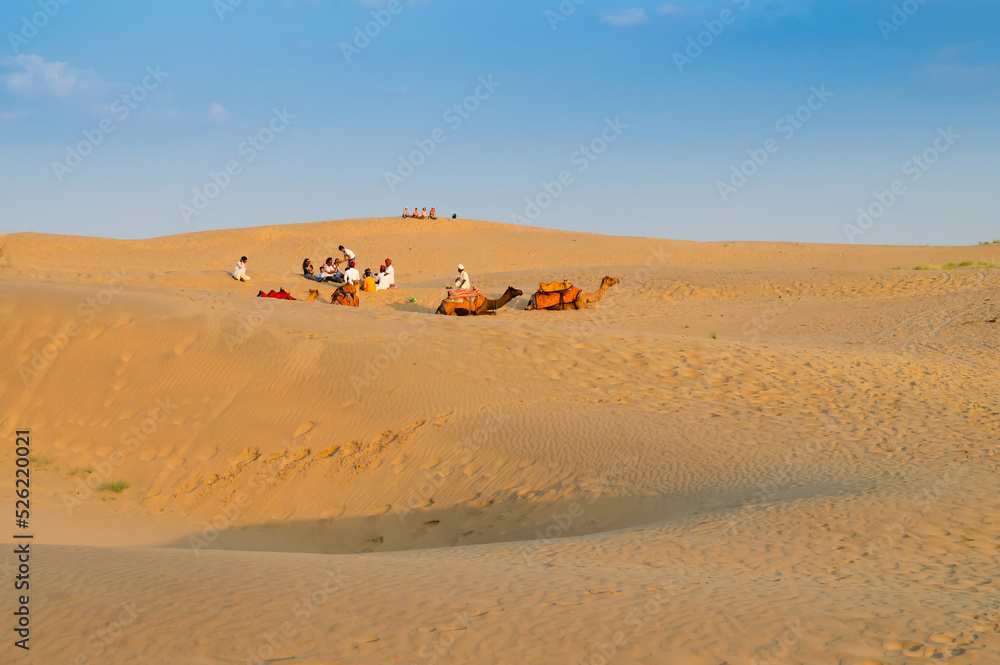 Tourists with camels, Camelus dromedarius, at sand dunes of Thar desert, Rajasthan, India. Camel riding is a favourite activity amongst all tourists visiting here. Tourists with camels, Camelus dromedarius, at sand dunes of Thar desert, Rajasthan, India. Camel riding is a favourite activity amongst all tourists visiting here.