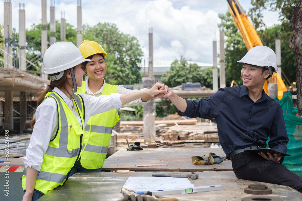 Professional engineer team making fist bump together to celebrating after success project or showing team spirit. Professional engineer team making fist bump together to celebrating after success project or showing team spirit.