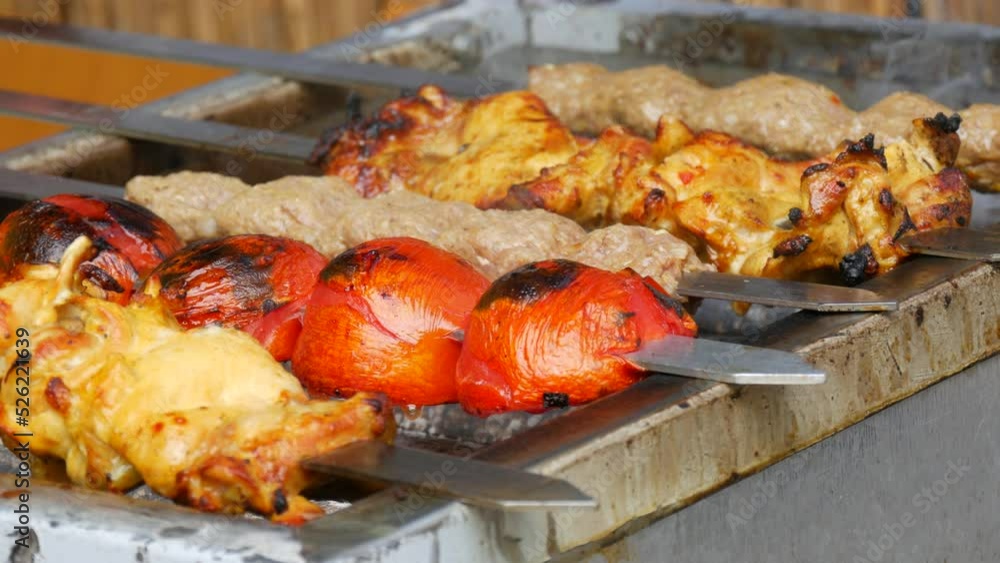 Pieces of fresh meat are grilled on a grill at a street food festival. Non vegetarian food, meat eaters Pieces of fresh meat are grilled on a grill at a street food festival. Non vegetarian food, meat eaters