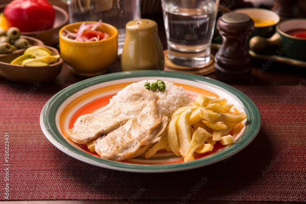 Fried chicken filet with french fries and rice peruvian gourmet restaurant comfort food Fried chicken filet with french fries and rice peruvian gourmet restaurant comfort food
