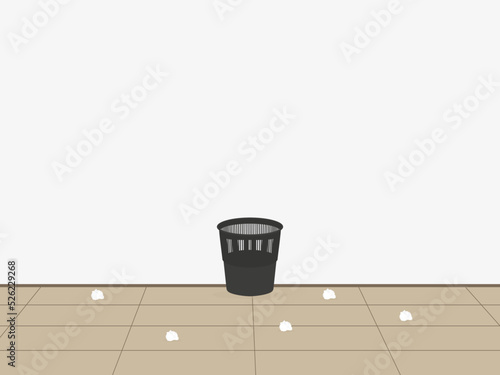 Black plastic wastepaper basket and paper on the floor indoors