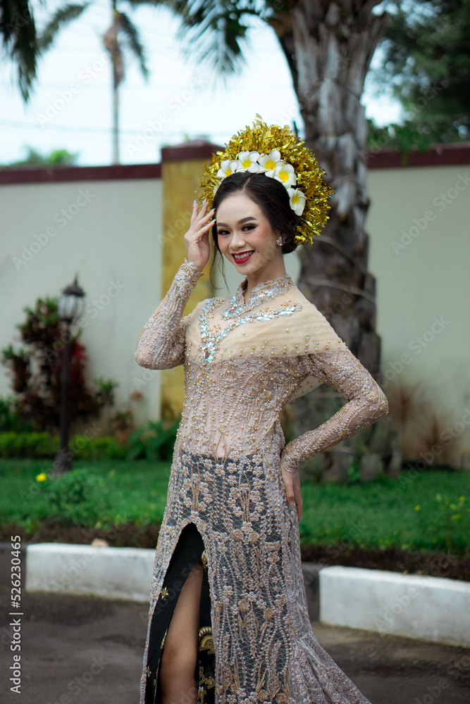 Beautiful Indonesian woman wearing KEBAYA. KEBAYA is a type of upper garment that is traditionally worn by women in Southeast Asia, especially in Indonesia. Beautiful Indonesian woman wearing KEBAYA. KEBAYA is a type of upper garment that is traditionally worn by women in Southeast Asia, especially in Indonesia.