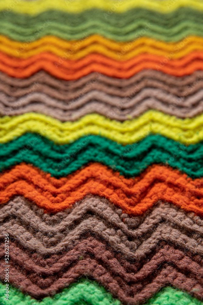 close-up of grandma's retro zigzag striped blanket, crocheted or knitted, grandma's house, cozy and warm
