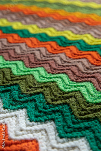 close-up of grandma s retro zigzag striped blanket  crocheted or knitted  grandma s house  cozy and warm