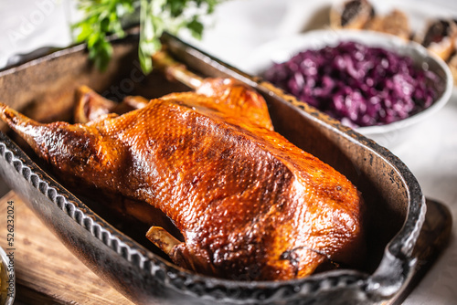 Billede på lærred Crispy baked goose in an original baking dish on the festive table
