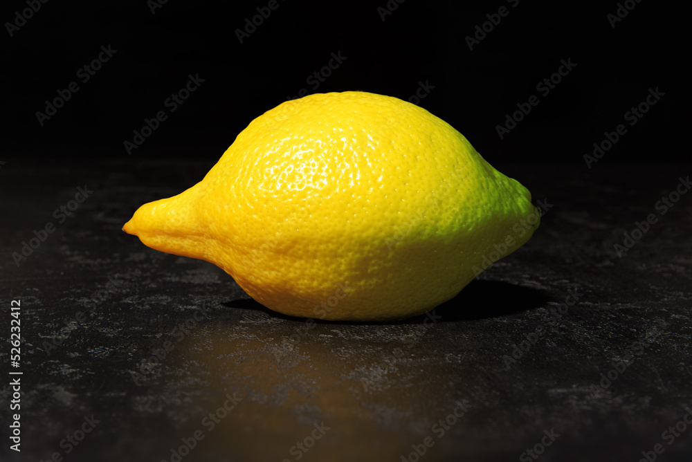 Etrog or citron on black background. Festival of Sukkot. Symbol of Torah-commanded holiday. Closeup.