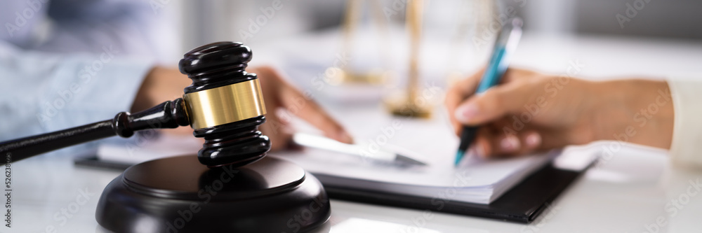 Judge Assisting Client To Sign Legal Document Judge Assisting Client To Sign Legal Document
