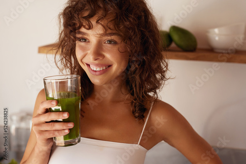 Woman Drinking Green Detox Juice, Smoothie Drink In Kitchen. Happy Smiling Girl With Glass Of Healthy Fresh Raw Vegetable Smoothie At Home. Diet Nutrition Concept 