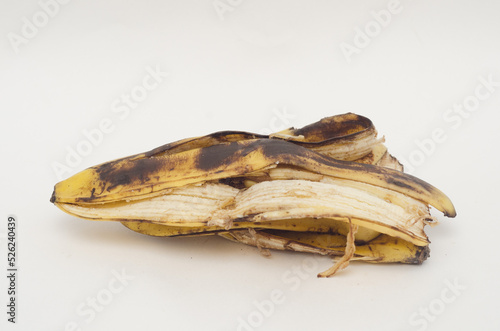 a pile of rotten banana skins on white background.