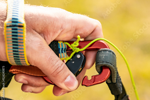 A carabiner of a paraglider, open