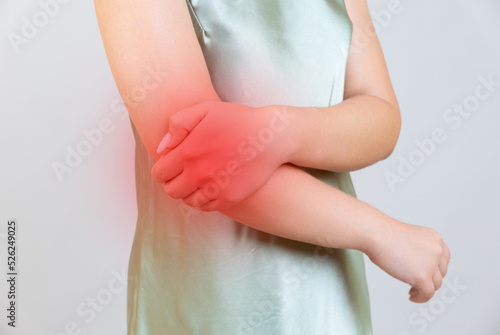 young woman experiencing pain in elbow joint
