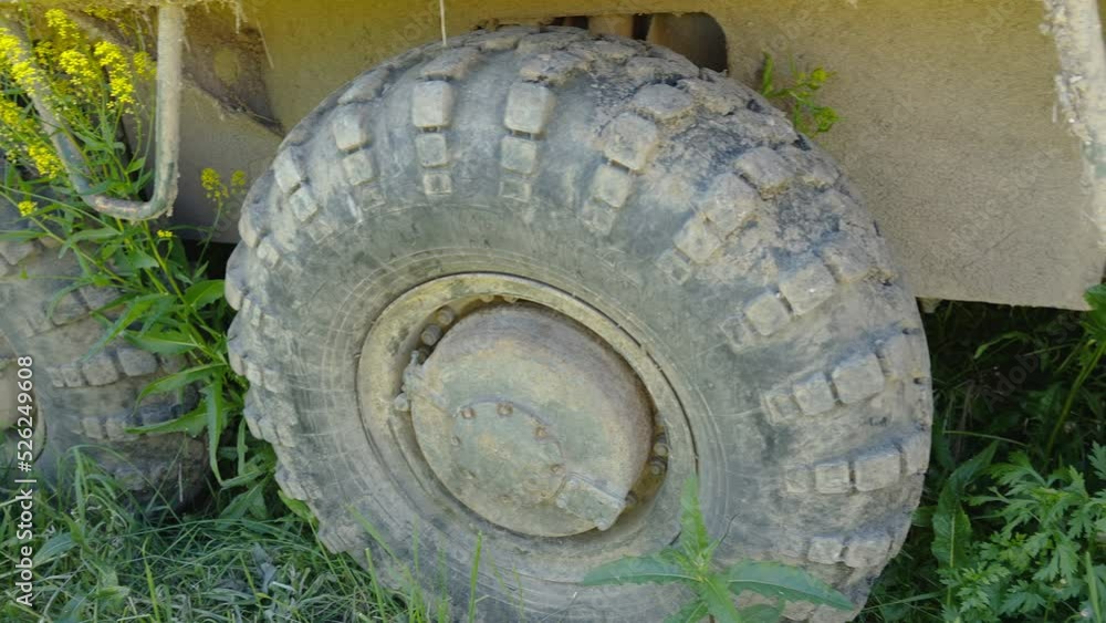 The muddy wheels of the military truck parked on the garage in Estonia The muddy wheels of the military truck parked on the garage in Estonia