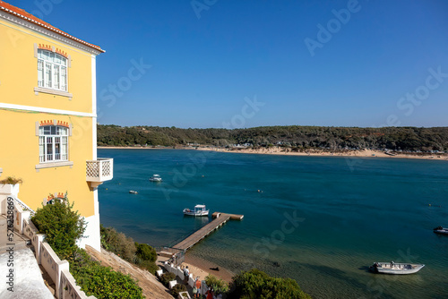 Breathtaking view of the mouth of the River Mira flowing into the Atlantic Ocean - Aquatic lifestyle sport in idyllic turquoise water, Vila Nova de Milfontes, Vicentine Coast Natural Park PORTUGA photo