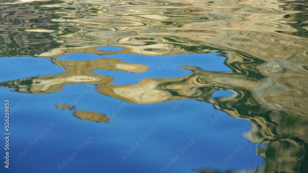 Abstract nature summer ocean sunset sea background. Small waves on water surface in motion blur with bokeh lights from sunrise. Holiday, vacation and recreational background concept. Selective focus.