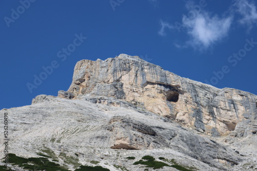 Val Badia, Italy-July 18, 2022: The italian Dolomites behind the small village of Corvara in summer days with beaitiful blue sky in the background. Green nature in the middle of the rocks.