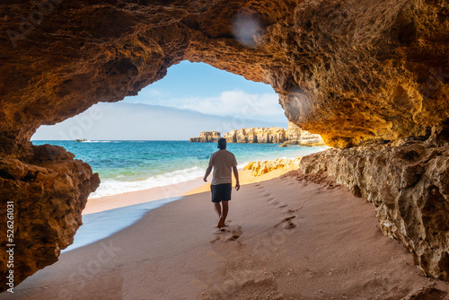 A man in the beach cave at Praia da Coelha, Algarve, Albufeira. Portugal