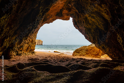 Natural cave in the Algarve in summer on the beach at Praia da Coelha, Albufeira. Portugal